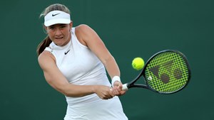 Mika Stojsavljevic hitting a backhand on court at Wimbledon