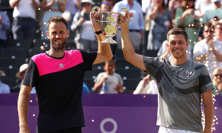 Michael Venus and Neal Skupski lifting their mens doubles title in the air at the cinch Championships