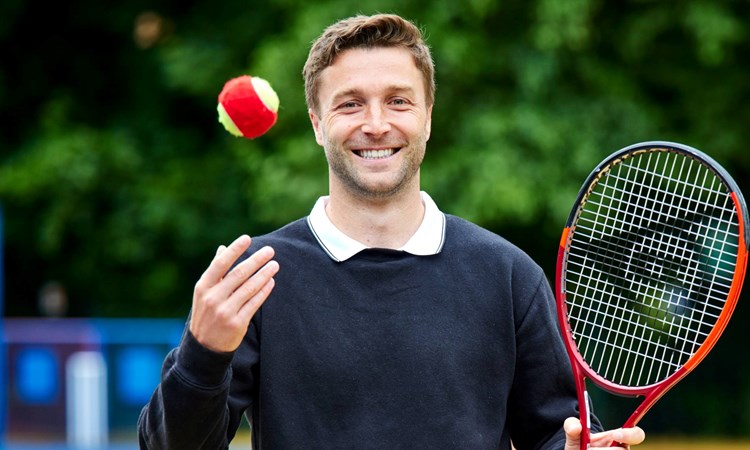 Liam Broady smiling during a visit to St Malachy RC Primary School