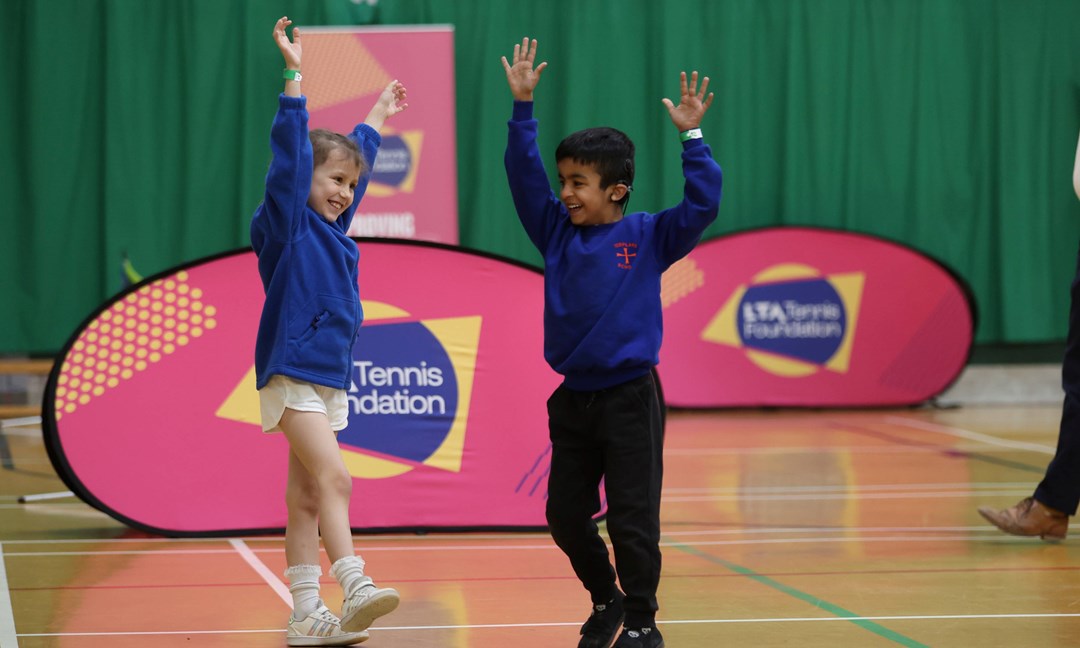 Two kids playing tennis at an LTA Tennis Foundation festival