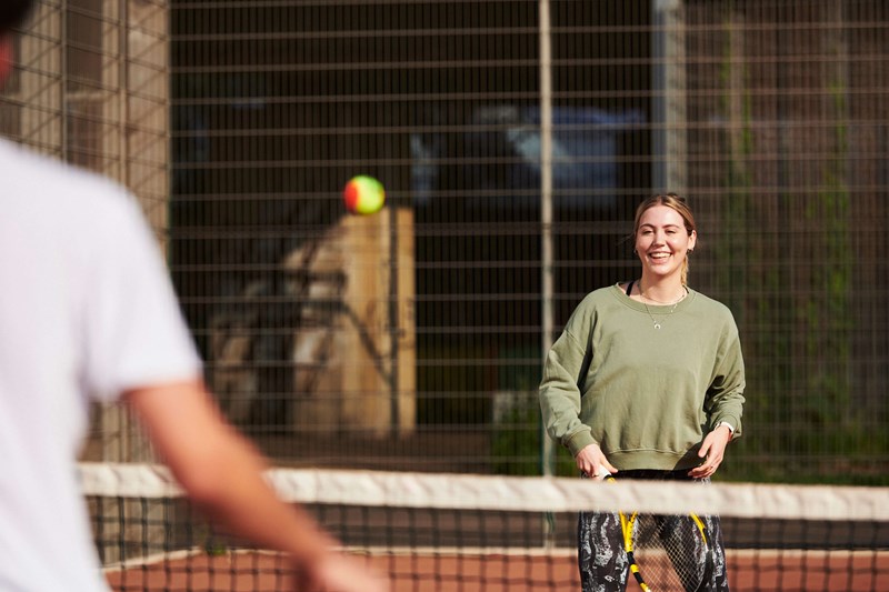 Female player laughing on court about to take a shot