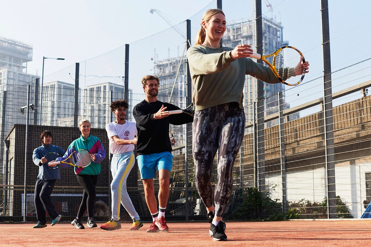 tennis-xpress-smiling-with-racket.jpg