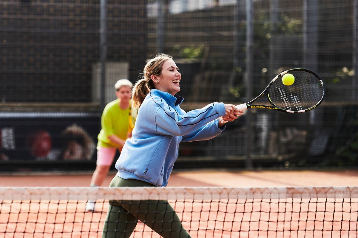 Woman-hitting-a-backhand-on-court.jpg