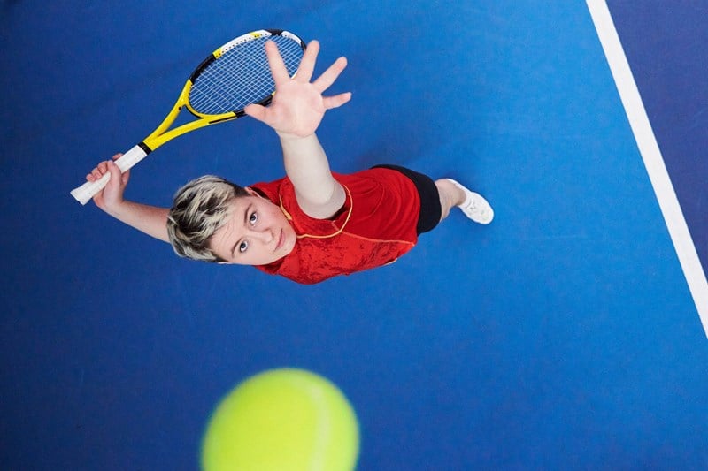 Top view of woman in the middle of a serve