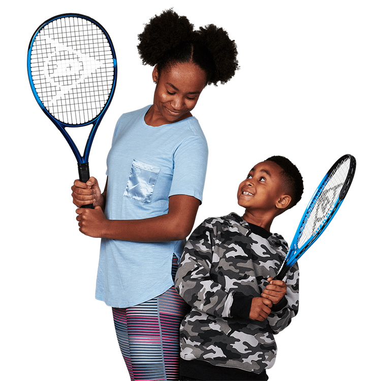 Boy looking up at a girl holding a tennis racket